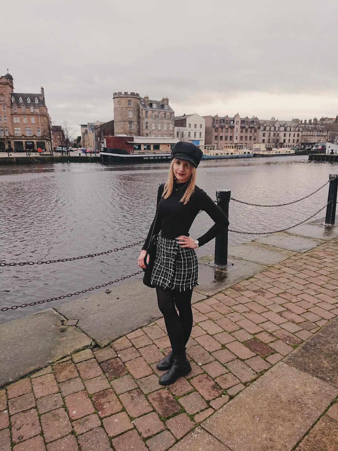 Samantha standing next to the water wearing a sparkly skirt