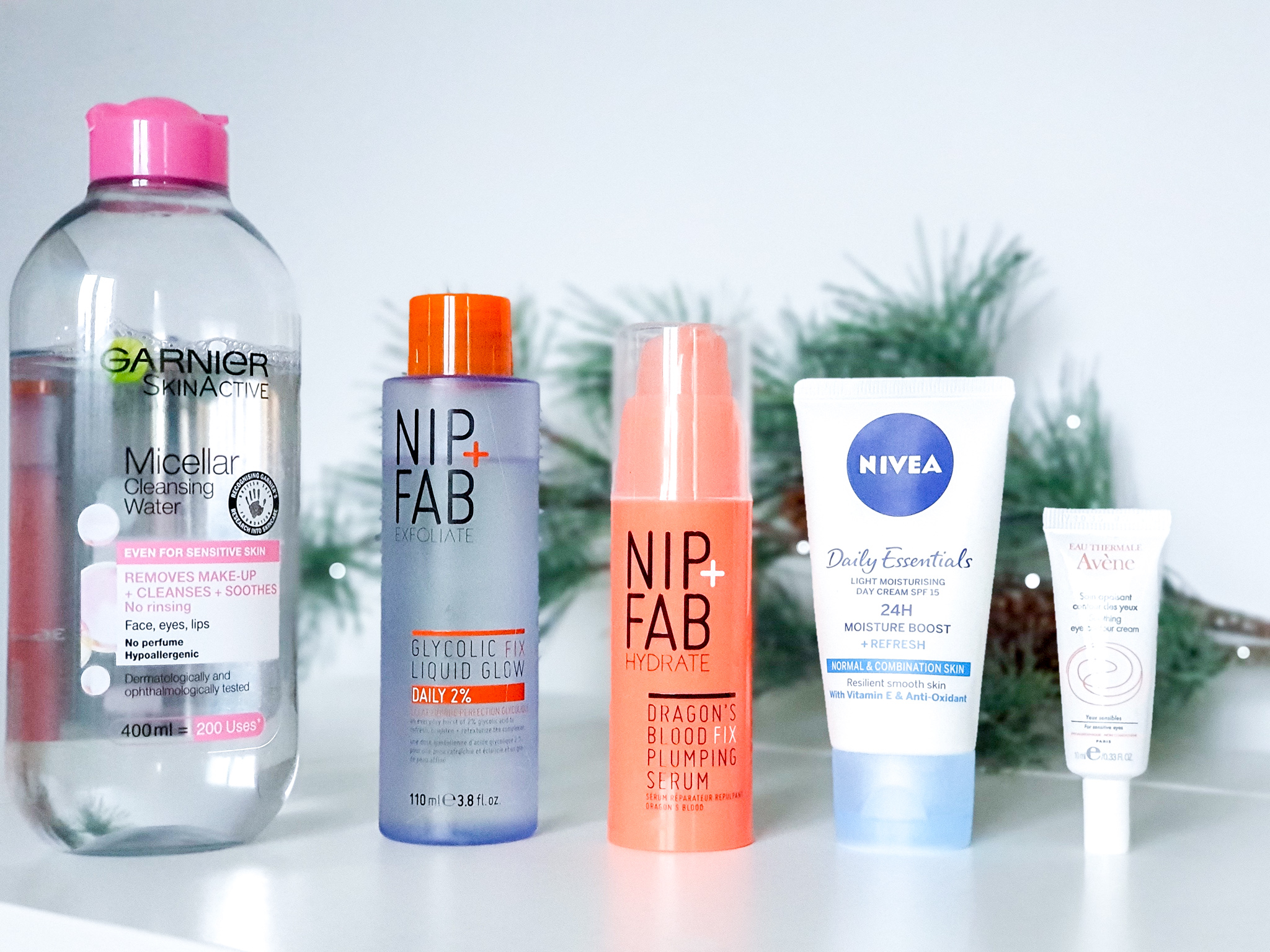Garnier Micellar water, Nip and Fab Glycolic Acid, Nip and Fab Dragonsblood Serum, Nivea Moisturiser and Avene Eye Cream bottles sitting in a row